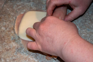 rolling the chicken breast